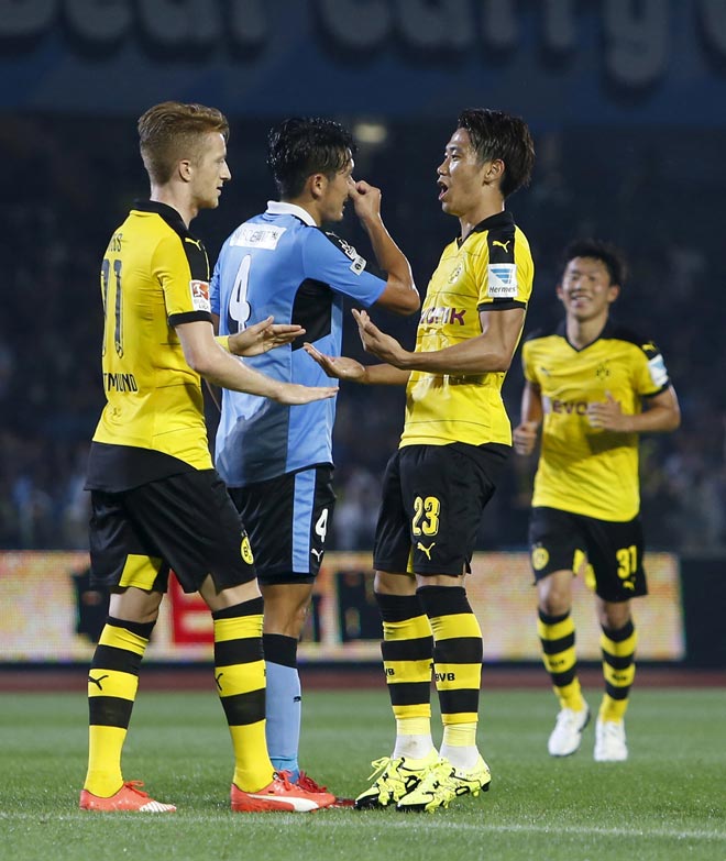 Borussia Dortmund’s Shinji Kagawa (secon dright) is congratulated by teammate Marco Reus after scoring during their friendly match against Kawasaki Frontale as part of Borussia Dortmund’s Asia Tour in Kawasaki, south of Tokyo, Japan.— Reuters photo