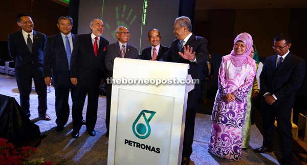 Adenan in a light moment with (from left) Morshidi, Asfia, Jabu, Sidek, and Fatimah prior to placing his palm on the podium to symbolically launch the Petronas event yesterday. - Photo by Muhammad Rais Sanusi 