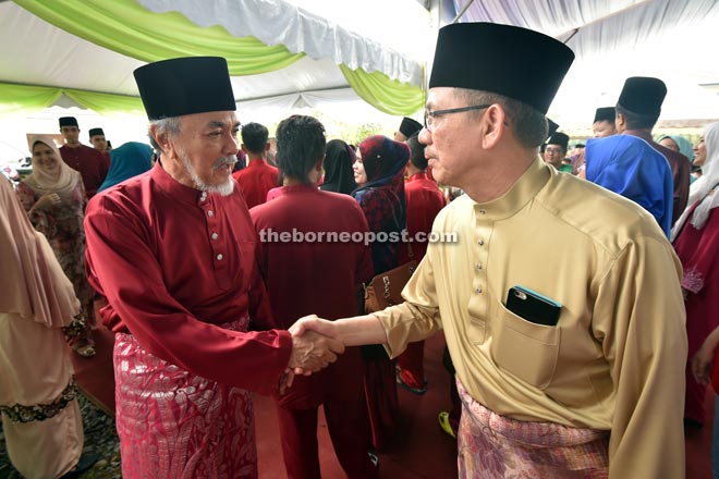 Fadillah (right) greeting Asfia upon his (Asfia) arrival at his residence for a Hari Raya visit yesterday. — Photo by Tan Song Wei