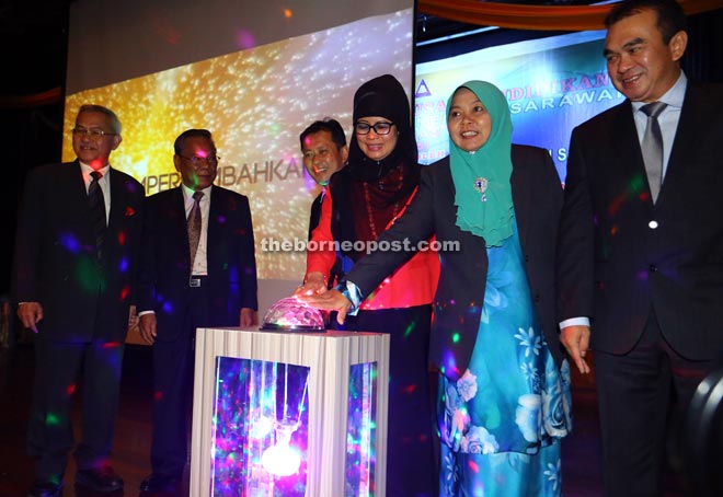 Fatimah (third right) and Rakayah (second right) touching the dome to symbolically launch the 50th Sarawak Secondary School Principals Education Management Conference. With them are (from left) Talip, Gramong, Ibrahim and Lawson (right). — Photo by Muhammad Rais Sanusi