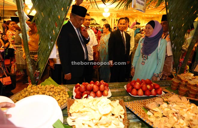 Adenan tasting a ‘jambu air’, which is among the fresh local fruits available at the buffet. - Photo by Muhammad Rais Sanusi