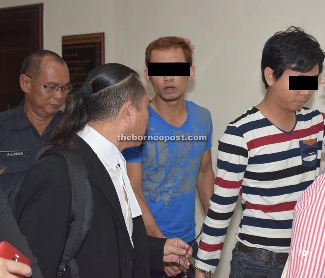  The two accused are seen with their lawyer. 