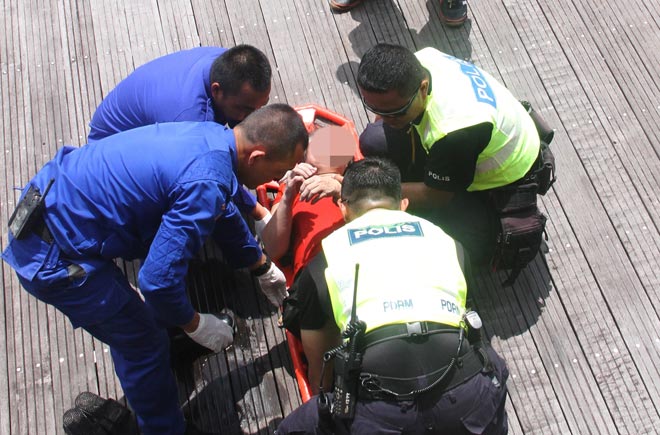 The elderly woman being attended to by police and Civil Defence Department personnel.