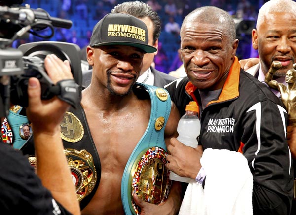 Floyd Mayweather Jr (left) poses for a picture after defeating Manny Pacquiao of the Philippines in their welterweight WBO, WBC and WBA title fight in Las Vegas, Nevada, in this May 2 file photo. — Reuters photo