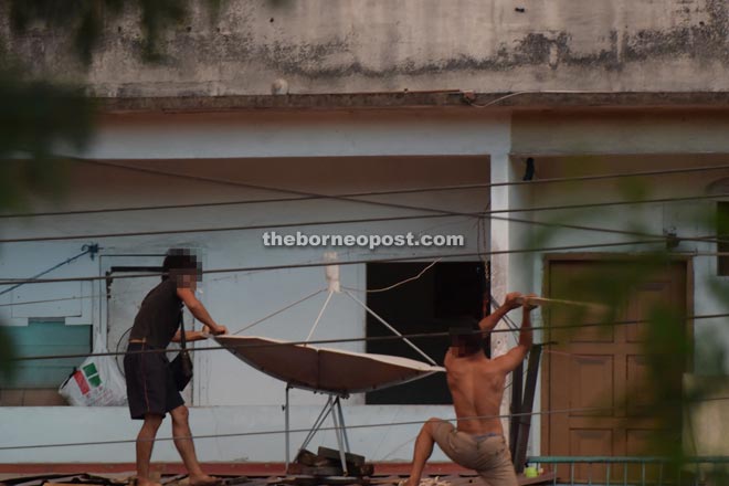 The two men fighting on the roof (pictured above and below)