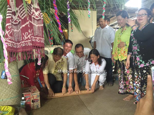 (Second from left) Ting, Chin, Chai and Lee roll a mat to mark the close of Gawai Dayak.