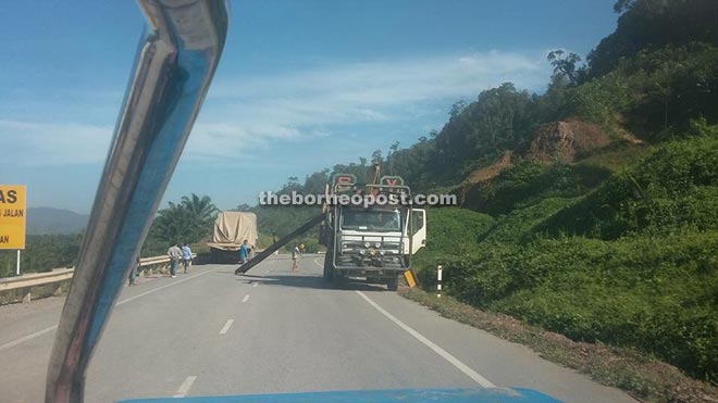 A ‘transformer’ truck tearing down a metal  barricade along the Bakun Road yesterday. 