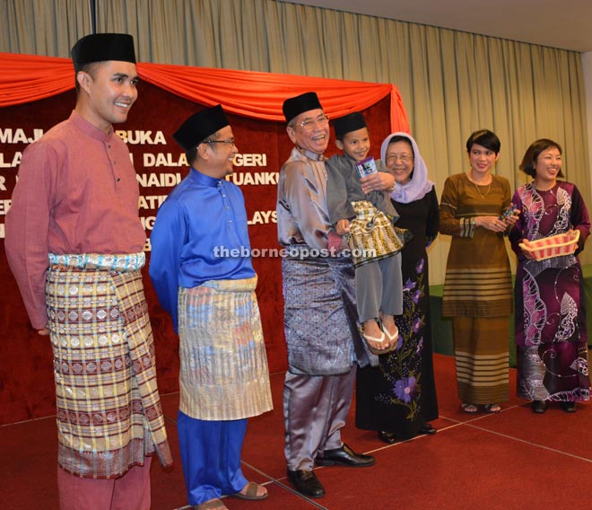 Wan Junaidi (third left) embrasing an orphan, as (from left) Shawal, Dr Annuar, Feona and others look on.