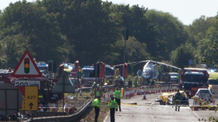 © AFP | Police and members of the emergency services work at the scene of a plane crash at Shoreham Airshow in Shoreham-by-Sea, England, on August 22, 2015 