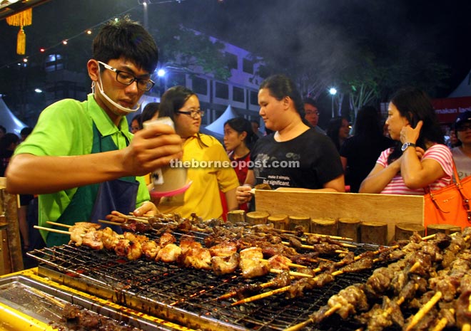 A trader selling barbecued chicken parts.