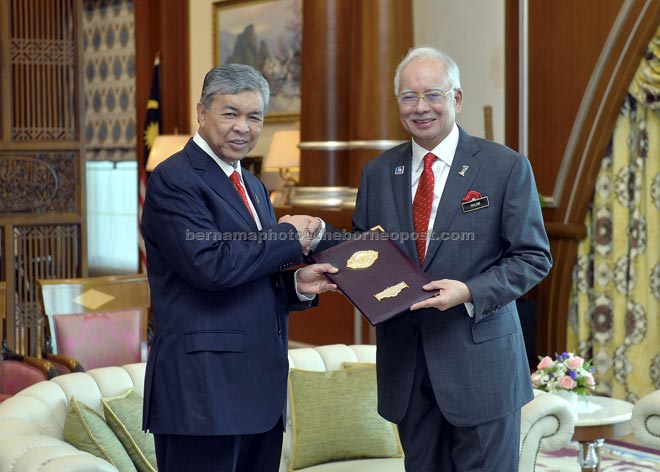 Najib (right) hands over the appointment letter to Ahmad Zahid. — Bernama photo