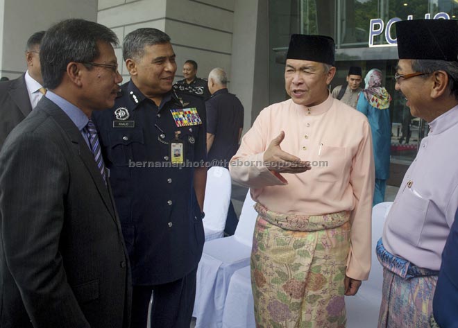 Ahmad Zahid (second right) shares a light moment with (from right) Musa Aman,  Khalid and Home Ministry chief secretary Datuk Alwi Ibrahim after chairing the meeting at Bukit Aman Police headquarters.  —  Bernama photo 