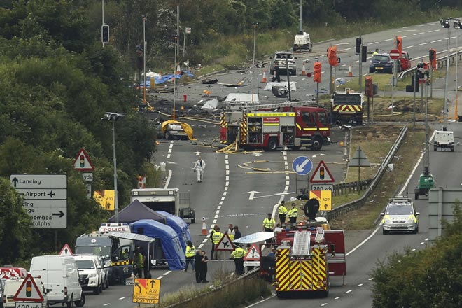 Emergency services and crash investigation officers work at the site where the Hawker Hunter fighter jet crashed onto the A27 road at Shoreham near Brighton, Britain. — Reuters photo