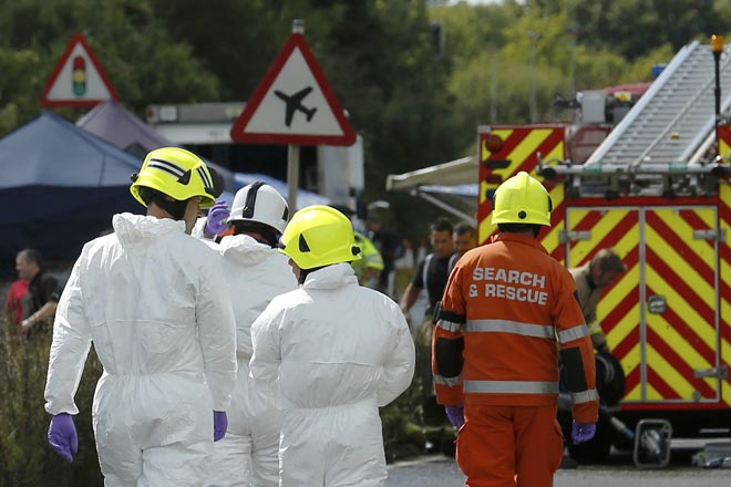 Emergency services and crash investigation officers work at the site where the Hawker Hunter fighter jet crashed onto the A27 road at Shoreham near Brighton. — Reuters photo