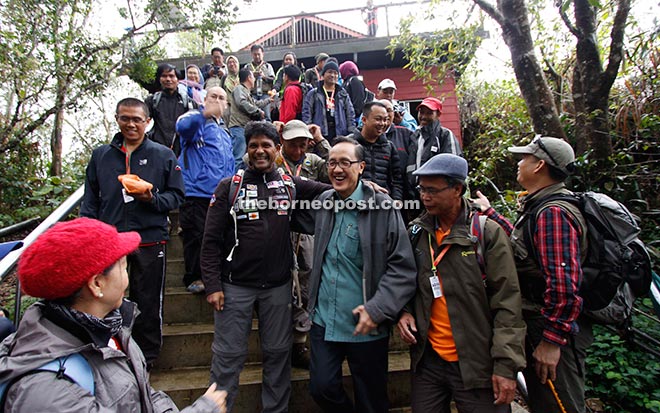 Tourism, Culture and Environment Minister Datuk Seri Panglima Masidi Manjun sharing a light moment with members of the first team to climb Mount Kinabalu since its closure after officiating the flagging off ceremony yesterday.