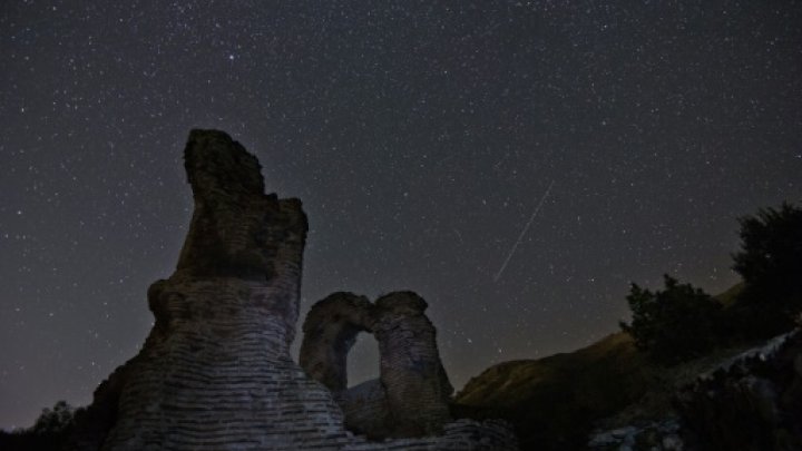 © AFP / by Marlowe Hood | A long exposure image showing a Perseids meteor (R) streaking across the night sky near the town of Pirdop, August 12, 2015 