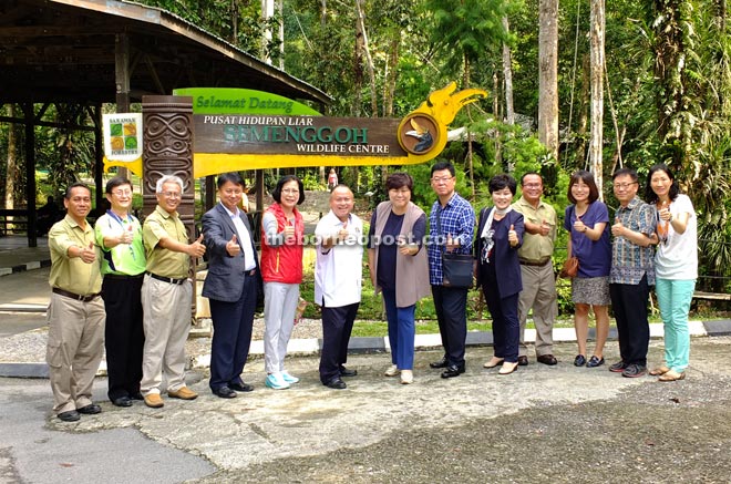 Chan (sixth left) and Kim (seventh left) posing for a group photo with Sarawak Forestry staff and councillors from both councils at the wildlife centre.