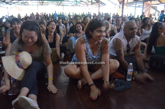 The audience beating on the floor in support of the musical camaraderie.