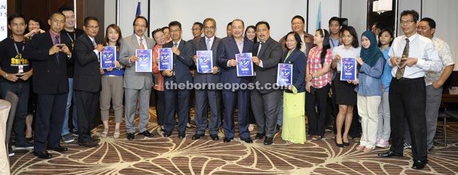 Hajiji, state leaders and the media showing the flyers of the month-long National Day celebration.