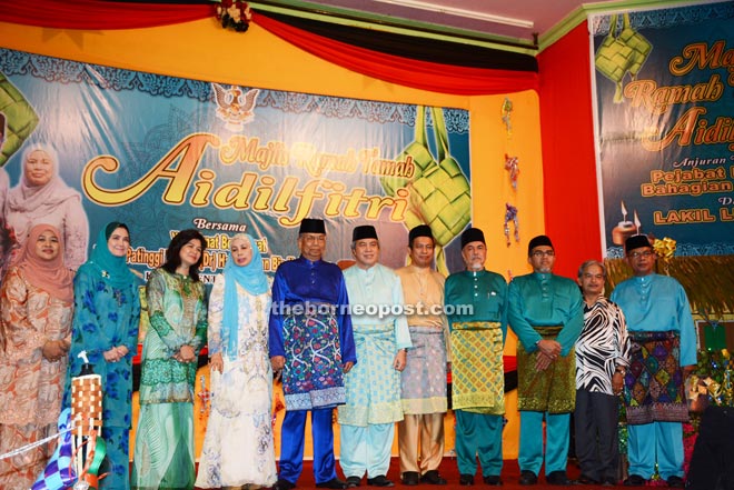 Adenan (fifth left), flanked by Jamilah (left) and Awang Tengah (right), poses for a photo call with other dignitaries. 