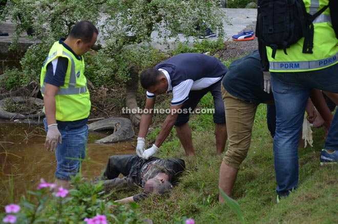 A policeman checks on the body of the deceased. 