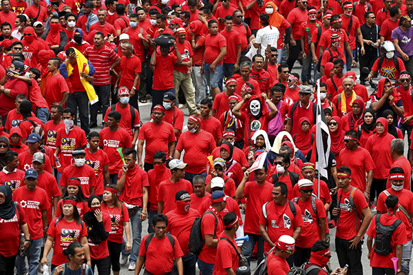 ‘Red Shirt’ demonstrators gather for a rally to celebrate Malaysia Day and to counter a massive protest held over two days last month that called for Prime Minister resignation over a graft scandal, in Kuala Lumpur. — Reuters file photo