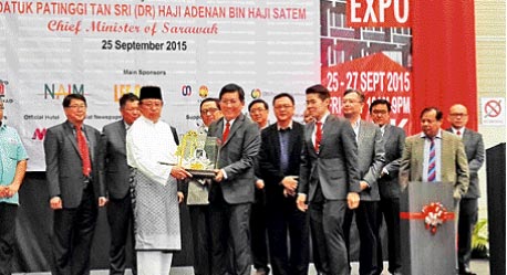 Abang Johari (third left) receiving a token of appreciation from Wong as other guest of honour look on after the opening ceremony of the Sheda Property Expo 2015 here yesterday.  