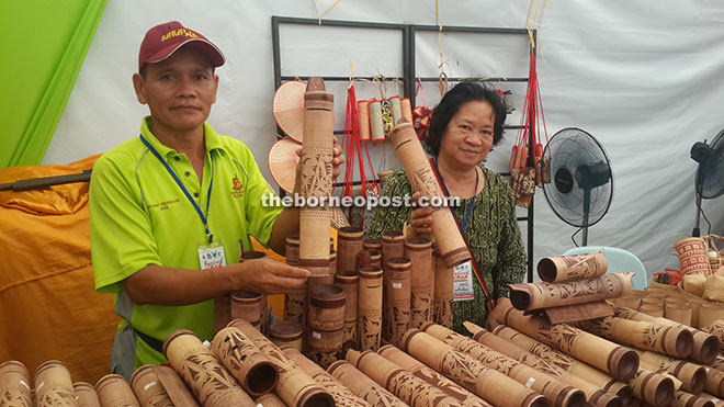 Edwin (left) showing his distinctively unique Bidayuh carved and painted bamboo.