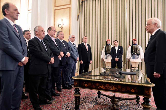 Greek Prime Minister Alexis Tsipras (back right) smiles as members of the new government take a civil oath in front of Greek President Prokopis Pavlopoulos (right) at the presidential palace in Athens  swearing-in ceremony of the new government in Athens. — AFP photo