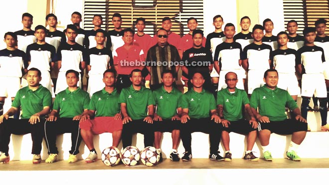 Team manager Ismail (standing second row, centre) with Miri Under-19 soccer team and tournament officials. 