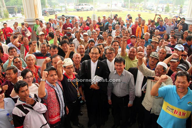 Baru (front, centre) and Krian assemblyman Ali Biju with the native landowners and supporters who were present at the Kuching Courthouse to show their support yesterday. — Photo by Chimon Upon