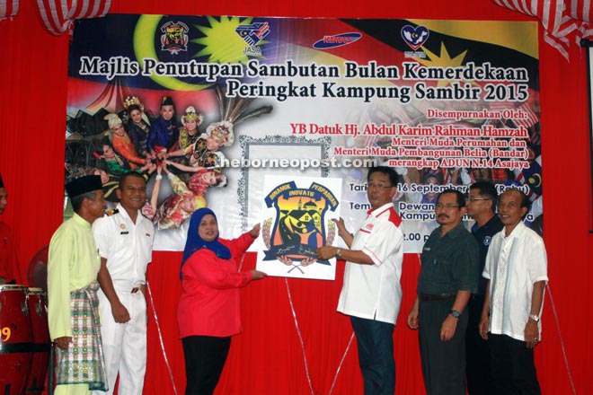 Abd Karim (right) and Rubiah launch the Kampung Sambir logo. — Photo by Jeffery Mostapa 