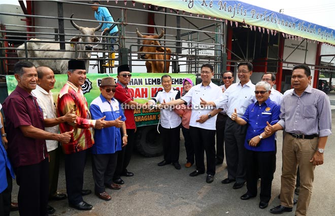  (From front sixth left) Naroden, Samarahan Member of Parliament Rubiah Wang, Julaihi, Abdul Karim, Mohamad Ali, and Aidel are seen during the handing over of the sacrificial animals. — Photo by Mohd Rais Sanusi  