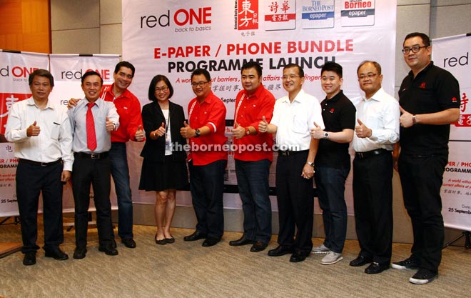 (From fifth left) Farid, Phyllis, RedONE chief operations officer Tee Yew Yaw, RedONE chief sales officer Ben Teh and See Hua Group Kuching area manager Wong Sing Seng (fourth right) gather for a photo call at the launch. 