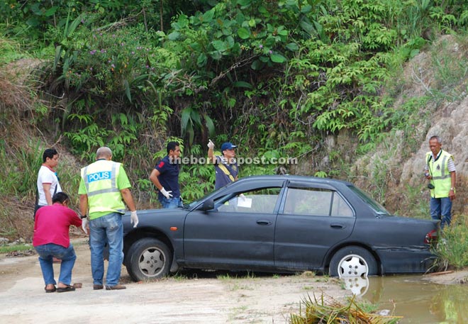 Policemen inspecting the scene.