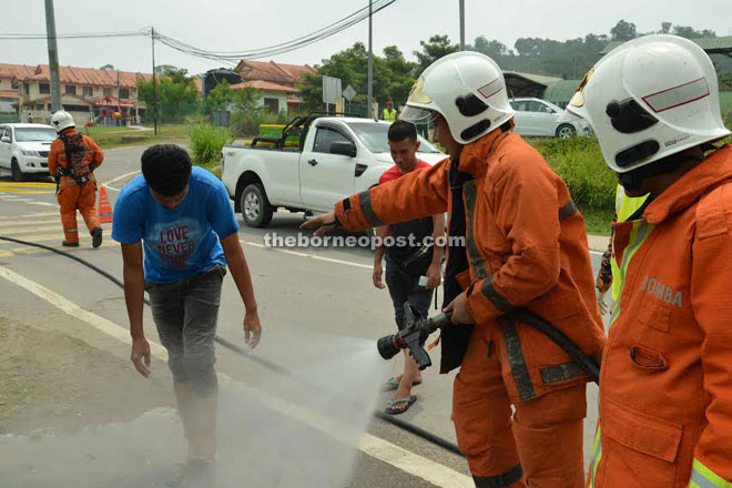 Fire and Rescue Services personnel spraying water at the lorry driver after he came into contact with the nitric acid.