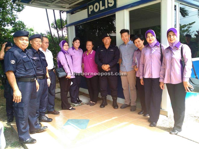 (Fourth left) Yijing, Poge and others at the police station in front of Farley Supermarket.