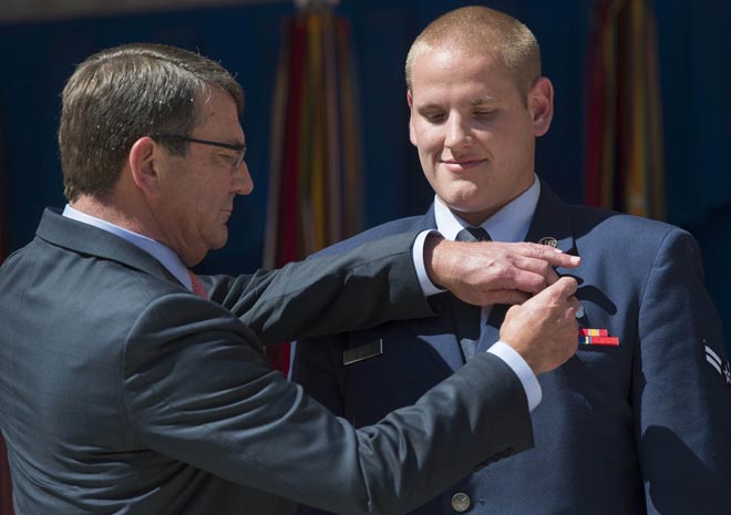 This Sept 17, file photo shows US Secretary of Defence Ashton Carter as he presents the Airman’s Medal to Stone (right) for his role in disarming a gunman on a Paris-bound train  during a ceremony at the Pentagon in Washington, DC. — AFP photo