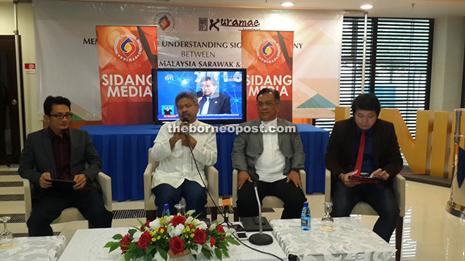 Mohd Fadzil speaking during the forum at Unimas campus yesterday. Also seen are Dr Mohamad Kadim (second right), Lau (right) and Dr Mohammad Affendy. — Photo by Matthew Umpang