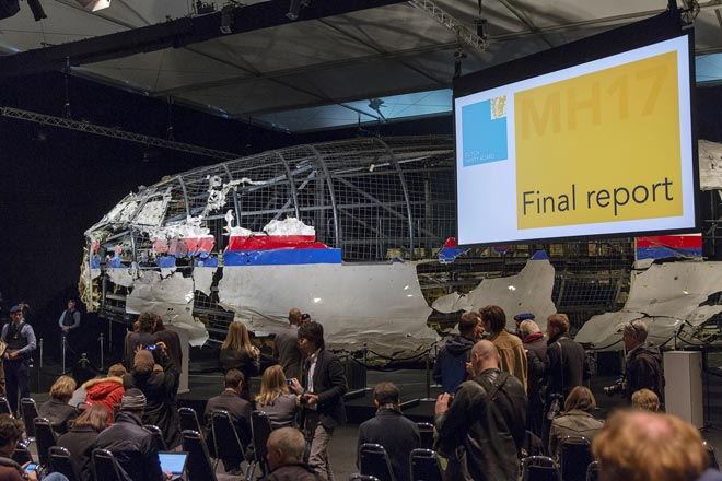 The reconstructed airplane serves as a backdrop during the presentation of the final report into the crash of July 2014 of Malaysia Airlines flight MH17 over Ukraine, in Gilze Rijen, the Netherlands. — Reuters photo