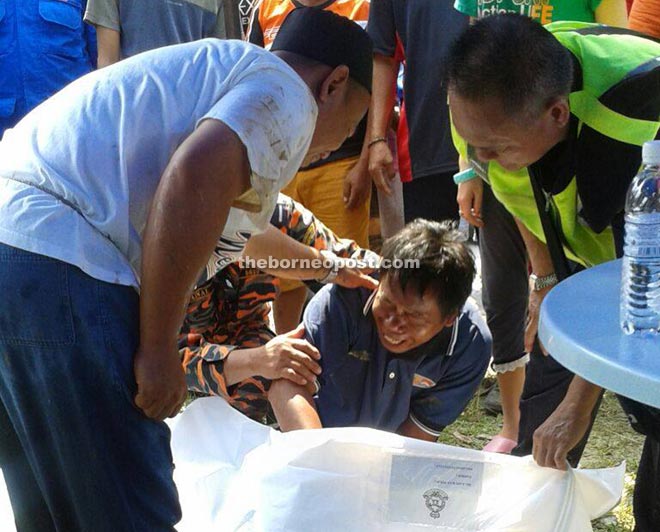 SAR personnel comforting Tahir, who broke down upon seeing his daughter’s body.