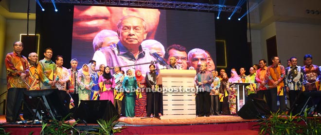 Sarawakian federal and state cabinet ministers together with elected representatives stand behind Adenan on stage during the Lan Berambeh Anak Sarawak 2015 dinner. — Photos by Muhammad Rais Sanusi 