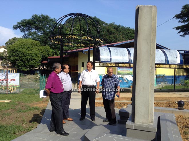 (From left) Soloman, Chan, Lai and restoration project committee member Edwin Dundang Bugak looking at the site where the new monument will be placed.