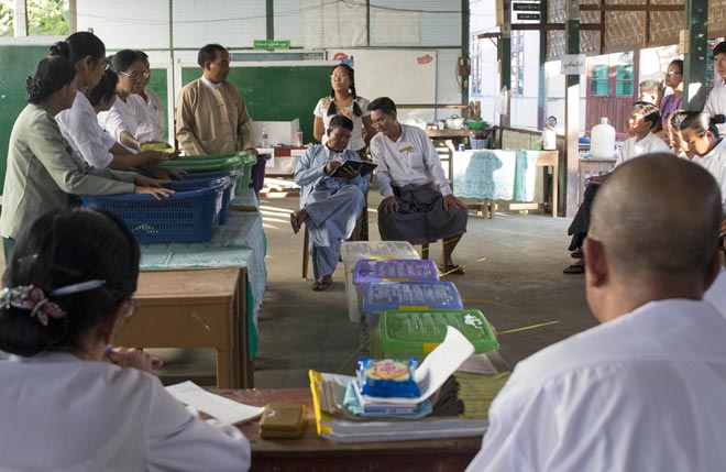 Officials check vote results at a polling centre in Mandalay.  — AFP photo