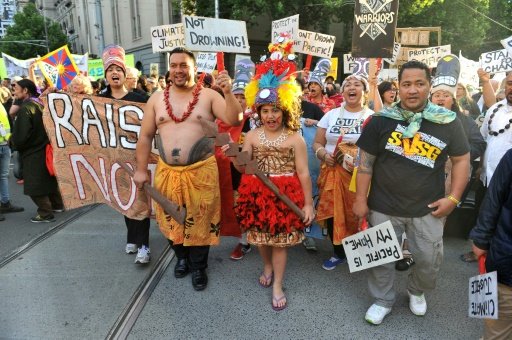 © AFP / by Mariëtte Le Roux | Pacific Islanders attend a rally calling for action on climate change in Melbourne on November 27, 2015