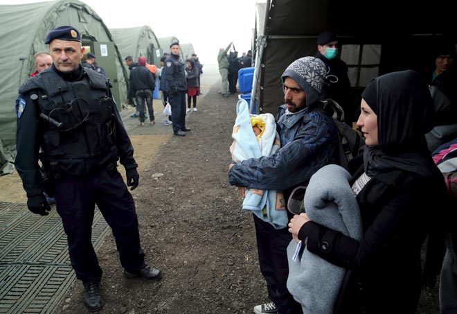 Migrants wait for registration at a new winter refugee camp in Slavonski Brod, Croatia. — Reuters photo
