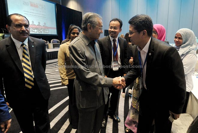 Dr Mahathir (second left) being introduced to participants after delivering his keynote address at the 2nd Annual Malaysia’s War On Corruption Symposium ‘It’s Now Or Never’. — Bernama photo