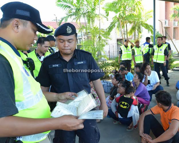 Police officers checking documents of illegal immigrants.