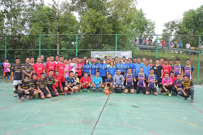 Jackline (standing at centre) posing with the players during the opening ceremony of the futsal competition.