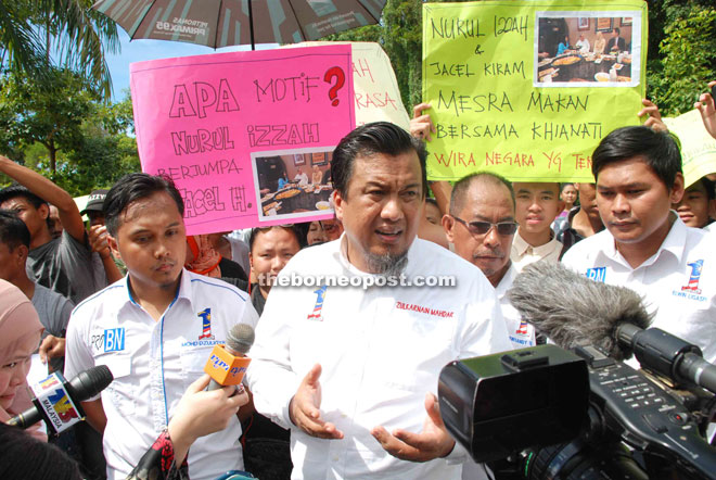 Zulkarnain (centre) meeting the press during the peaceful demonstration yesterday.